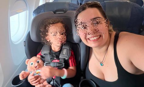 A smiling toddler on his third(!) airplane trip already, along with pretty smiling mom.